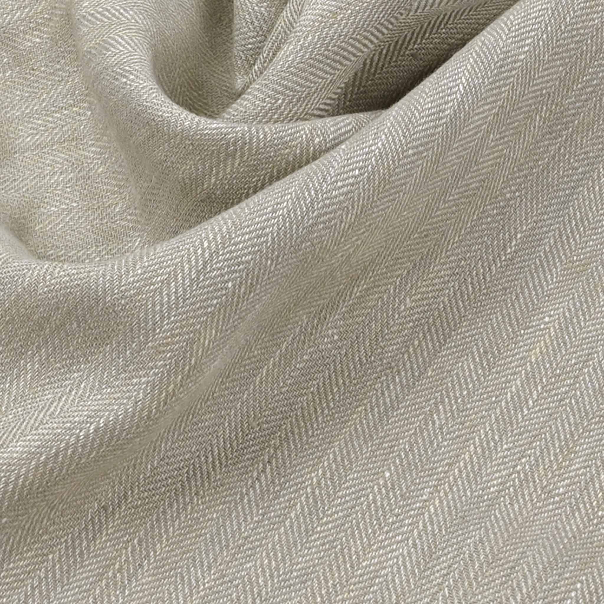 Wrinkled taupe herringbone linen fabric made from natural fibers, textured with a natural drape and luxurious hand, suitable for summer clothing.